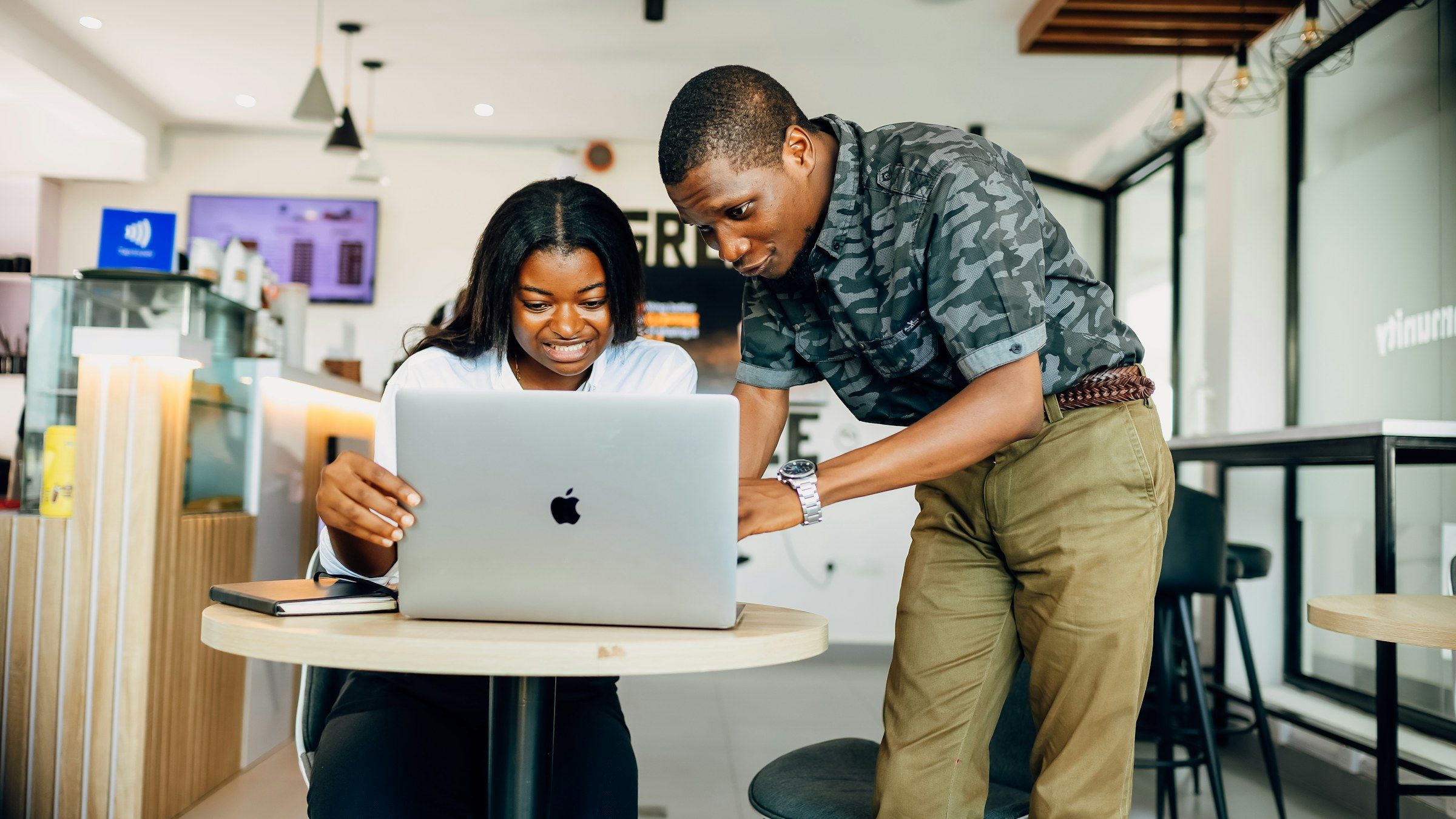 Two Hodari colleagues reviewing work together on a laptop